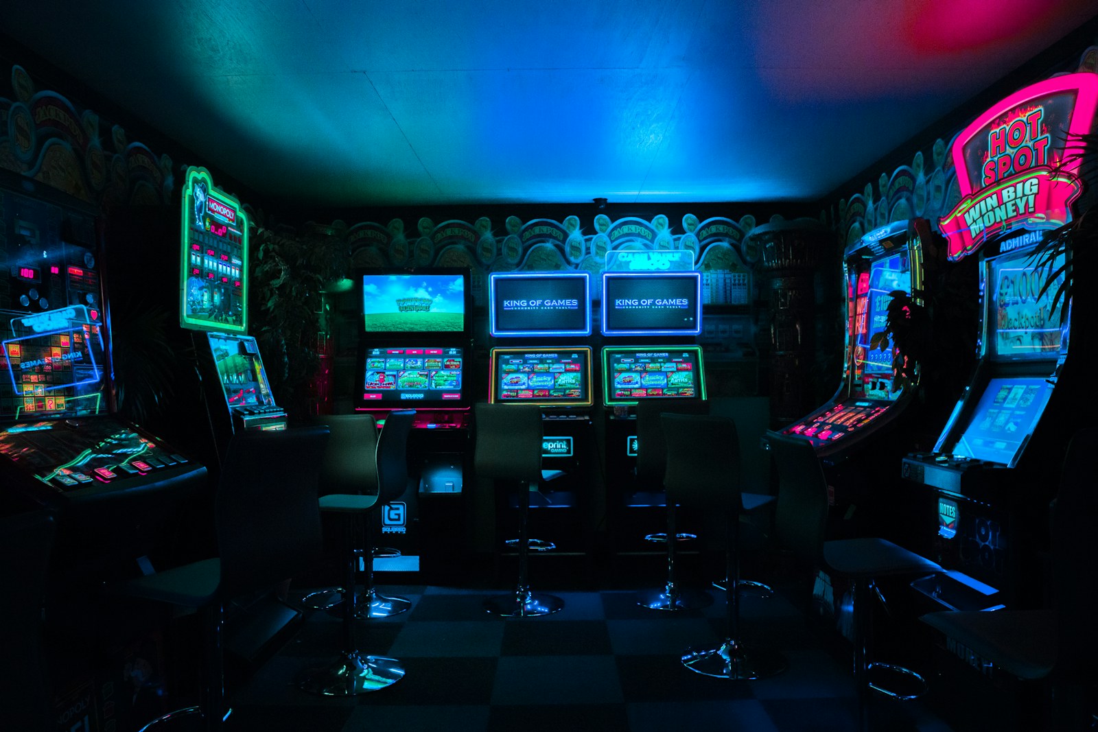 Dim arcade lights and a player silhouette.